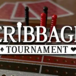 Cribbage tournament banner over a cribbage board with scoring pegs on a wooden table